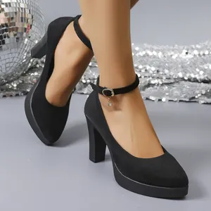 Elegant black suede block heel pumps with ankle straps and decorative charm detail