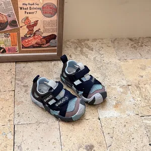 Detailed macro view of navy blue closed-toe sport sandals for kids placed on a stone floor