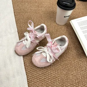 Pink girls' breathable mesh sneakers with ribbon bows and soft non-slip soles.