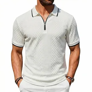 Macro detail of men's white textured polo shirt featuring a quarter-zip and black trim accents