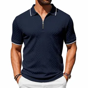 Macro detail of navy blue heavyweight jacquard polo shirt with silver zipper closure.