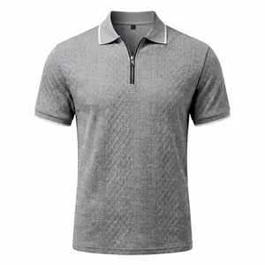 Close-up of grey men's jacquard polo shirt featuring a zip collar and fine textures