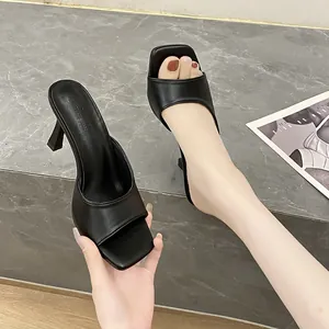 Close-up view of elegant black square toe high heel mule sandals with padded strap