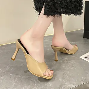 Detail view of elegant beige French style square toe high heel mules with thin heels