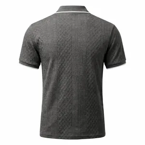 Detailed macro view of dark grey men's short sleeve polo shirt with textured jacquard knit.