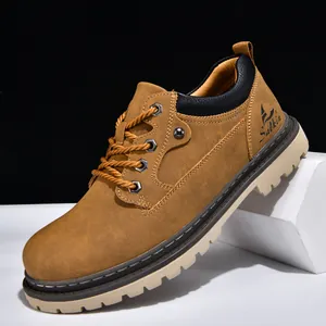 Detail view of brown men's work boot with rugged sole and metallic eyelets