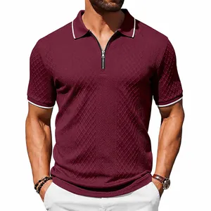 Detailed macro view of burgundy men's polo shirt featuring a zip neck and jacquard texture