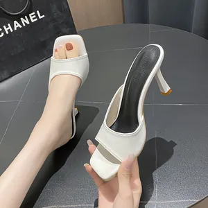 Close-up of white French square toe high heel sandals with elegant stiletto heels