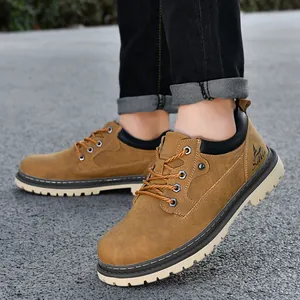 Macro detail shot of brown leather men's work boots being worn on outdoor asphalt pavement