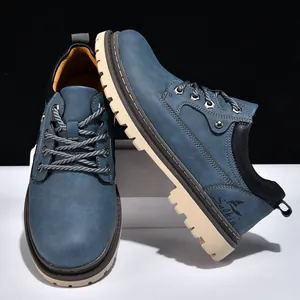 Detailed side view of blue nubuck men's mid-top work boots featuring thick durable lug soles