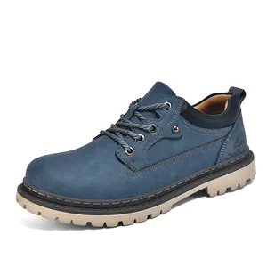 Detail view of blue nubuck men's work boots with durable beige lug sole