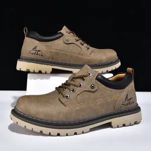 Detailed side view of brown men's Martin work boots with durable rubber lug soles