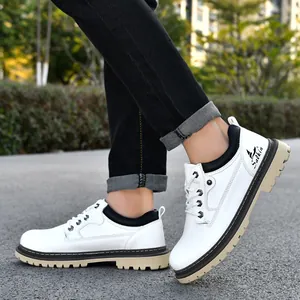 Detail shot of men's white work boots featuring lug soles and black ankle collars