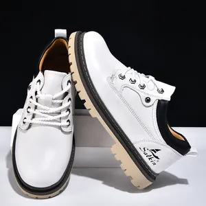 Detail view of stylish men's white and black leather work boots with thick rugged soles