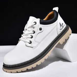 Detail of white leather mens work boot with durable lug sole and black ankle trim