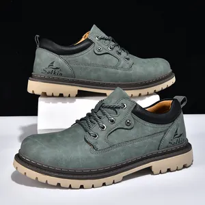 Close-up of dusty green men's work boots with thick cream lug soles