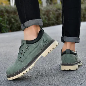Close-up view of stylish green men's work boots featuring durable rubber lug soles