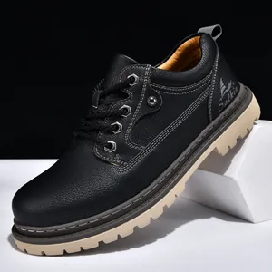 Detailed macro view of the black leather texture and stitching on a men's work boot