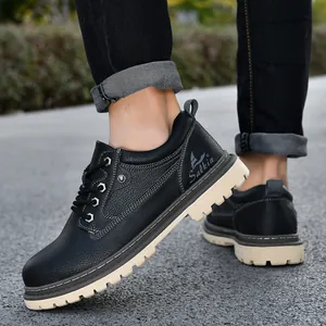 Side profile detail of men's black leather mid-cut work boots with rugged beige soles