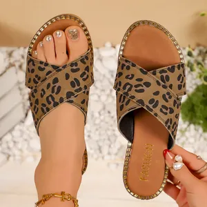 Close-up detail of stylish leopard print cross-strap flat sandals for women summer