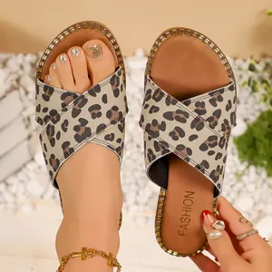 Detailed close-up view of leopard print criss-cross strap flat sandals for summer