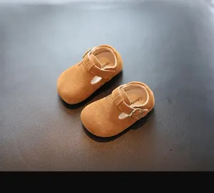 Vue détaillée de chaussures en daim marron pour bébés avec bride en T et semelle souple