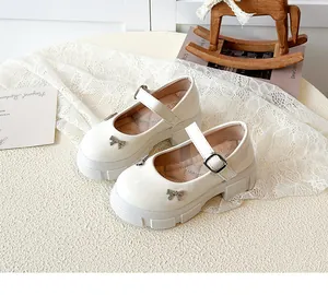 Beige retro platform Mary Jane shoes with rhinestone bow detail on lace background