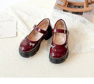 Elegant burgundy patent leather Mary Jane shoes with rhinestone bow on lace fabric