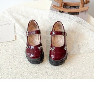 Vintage burgundy patent leather Mary Jane shoes with thick soles and cute bow charms