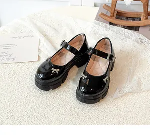 Macro view of black patent leather retro thick-soled Mary Jane shoes with rhinestone bow