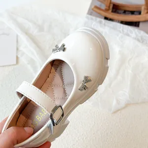 Elegant white Mary Jane shoes for girls featuring rhinestone bows and platform soles.
