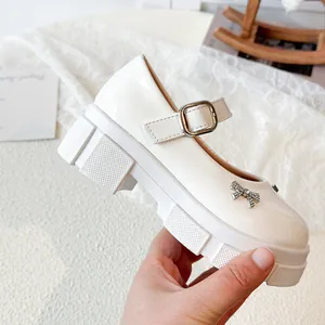Elegant cream white patent leather platform Mary Jane shoes with rhinestone bow detail