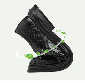 Close-up of flexible black perforated leather shoe showing soft texture