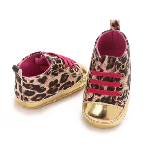 Detailed view of leopard print baby walking shoes featuring gold toe caps and pink laces