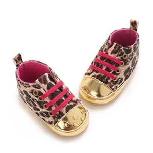 Leopard print baby walking shoes featuring a shiny gold toe and hot pink laces.