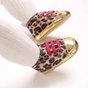 Detailed view of leopard print baby walking shoes with gold toe caps and pink laces