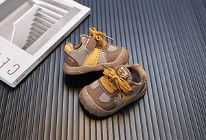 Dettaglio delle scarpe marroni per neonati con mesh traspirante e logo panda