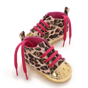 Detail view of leopard print baby shoes with pink laces and gold metallic toe caps