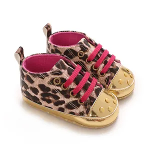 Leopard print baby walking shoes with pink laces and shiny gold toe caps.