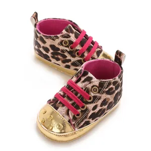 Close-up detail of leopard print baby walking shoes with pink laces and gold metallic toe