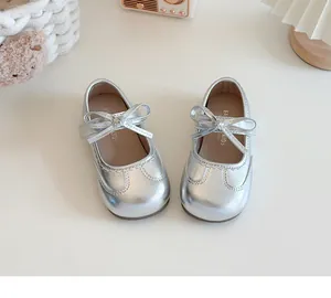Top view of shiny silver baby girls' Mary Jane shoes with cute bow detail and soft sole