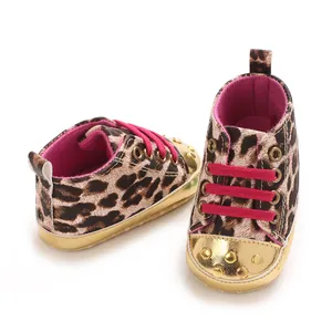 Detailed view of leopard print baby walker shoes with pink laces and gold studs