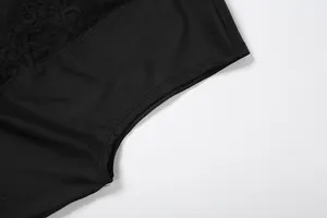 Close-up detail of exquisite lace splicing and stitching on a black sleeveless vest
