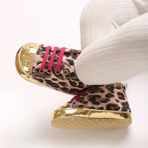 Close-up of leopard print baby pre-walker shoes with gold trim and pink laces