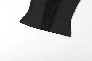 Detailed close-up of a black sleeveless vest featuring lace trim and small buttons