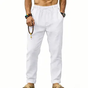 Detail shot of white men's loose linen straight trousers with elastic drawstring waist