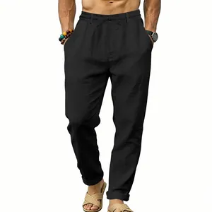 Detail view of men's loose black linen pants with adjustable drawstring waist and side pockets.