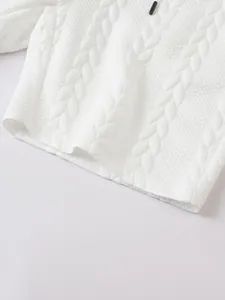 Detail macro view of white jacquard fabric texture on men's casual drawstring shorts