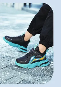 Detailed shot of trendy black and teal boys' sports sneakers with durable leather finish