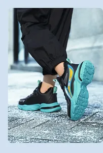 Close-up of boys' black sneakers with cyan non-slip soles and warm fleece lining